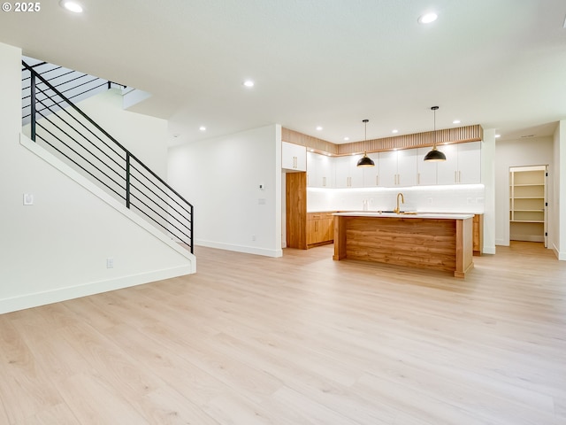 5412 NE 111th St, Vancouver, WA 98686 - kitchen with recessed lighting, light wood-style flooring, a sink, baseboards, and light countertops