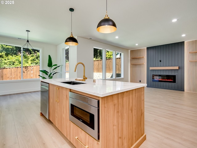 5412 NE 111th St, Vancouver, WA 98686 - kitchen with a sink, appliances with stainless steel finishes, modern cabinets, light wood-type flooring, and a kitchen island with sink