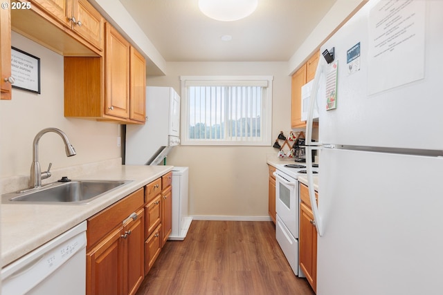 kitchen with dark hardwood / wood-style flooring, sink, and white appliances