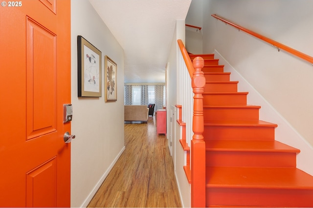 stairs with wood-type flooring