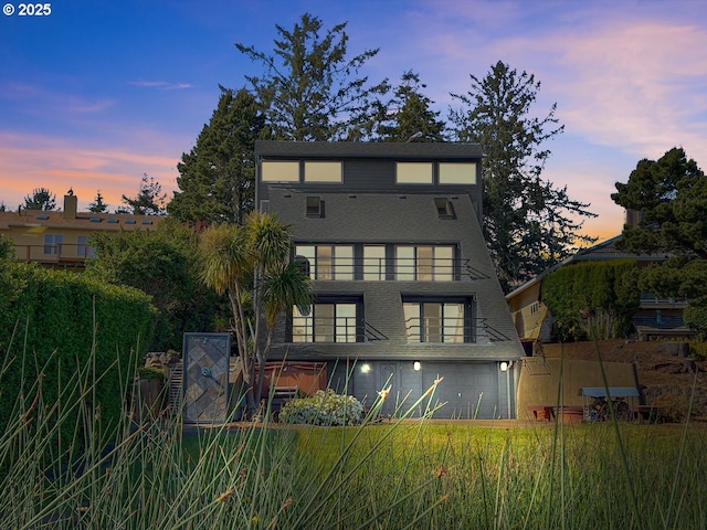 2036 NE Lagoon Ln, Lincoln City, OR 97367 - rear view of house with a balcony and a garage