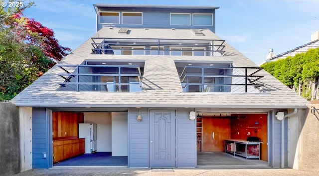 2036 NE Lagoon Ln, Lincoln City, OR 97367 - view of front of house featuring a balcony, a garage, and a shingled roof