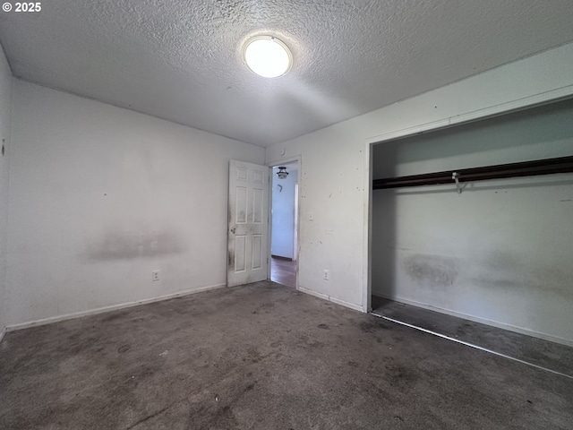 unfurnished bedroom with baseboards, a closet, carpet flooring, and a textured ceiling