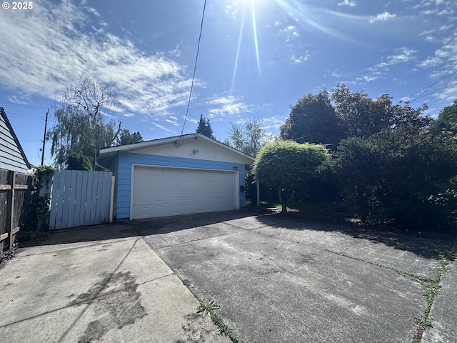 detached garage featuring fence