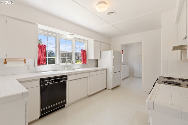 3034 Fisher Rd, Roseburg, OR 97471 - kitchen with dishwasher, tile countertops, freestanding refrigerator, a sink, and decorative backsplash