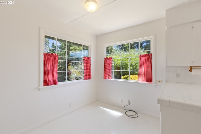 3034 Fisher Rd, Roseburg, OR 97471 - unfurnished dining area featuring plenty of natural light and baseboards