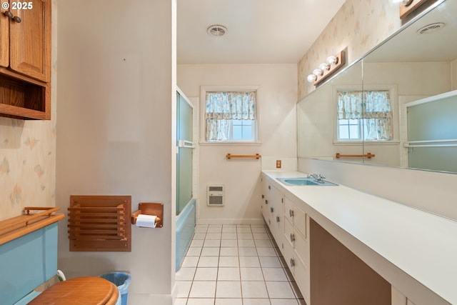 3034 Fisher Rd, Roseburg, OR 97471 - full bath featuring tile patterned flooring, vanity, heating unit, toilet, and bath / shower combo with glass door
