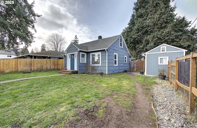 bungalow-style house with an outbuilding, a fenced backyard, a front lawn, and a shingled roof