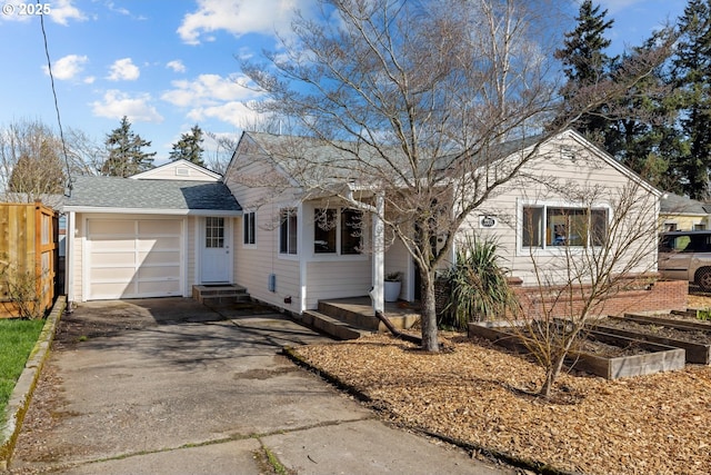 ranch-style house with roof with shingles, entry steps, fence, a garage, and driveway