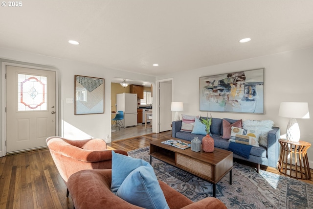 living area featuring recessed lighting and wood-type flooring