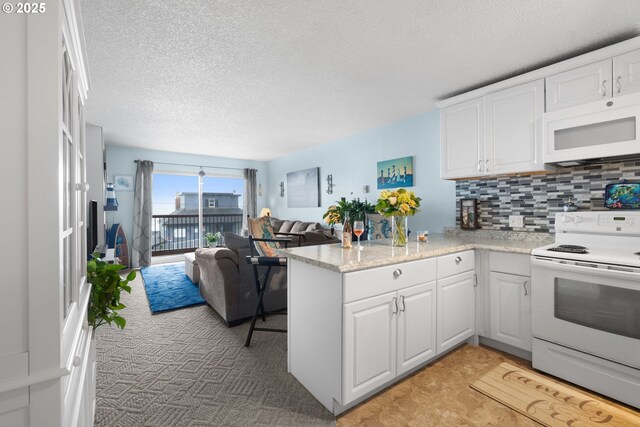 1415 NW 31st Pl Unit 166, Lincoln City, OR 97367 - kitchen featuring white appliances, white cabinetry, tasteful backsplash, and a textured ceiling