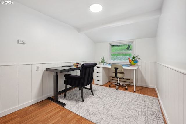 office space with vaulted ceiling with beams, light hardwood / wood-style flooring, and a baseboard radiator