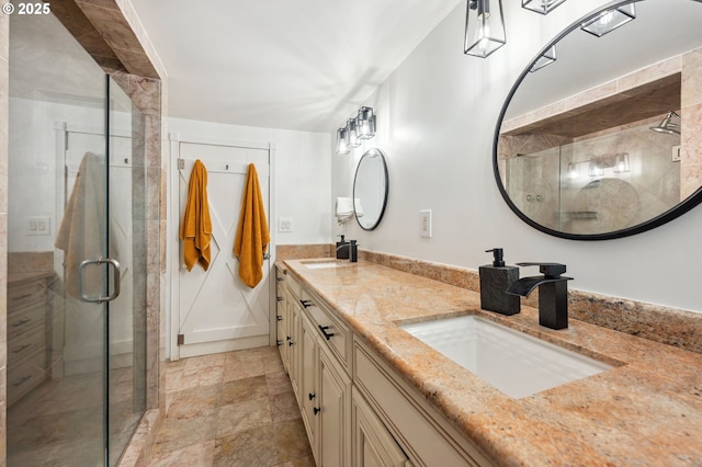 bathroom with a shower with door and vanity