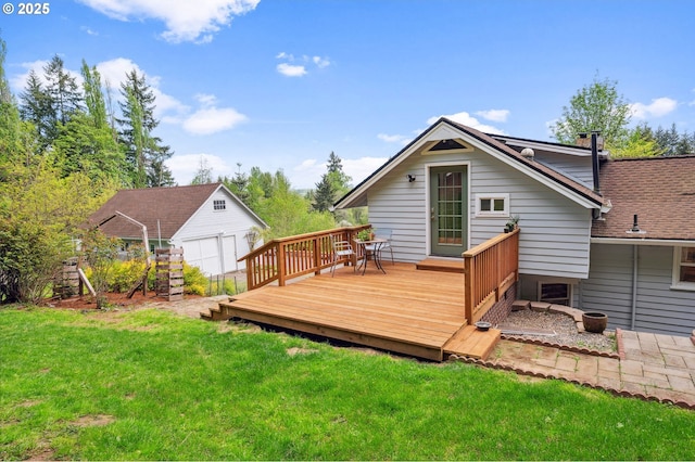 back of property featuring an outbuilding, a yard, and a wooden deck