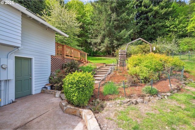 view of yard featuring a patio area and a wooden deck