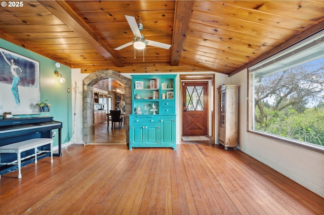 interior space with lofted ceiling with beams, wooden ceiling, ceiling fan, and light hardwood / wood-style floors