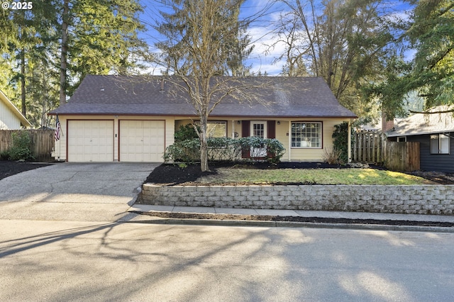 ranch-style house featuring a garage and a front yard