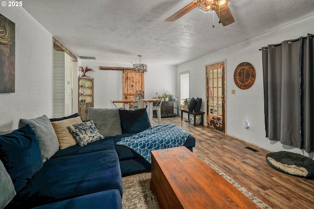 4435 Hazelgreen Rd NE, Salem, OR 97305 - living room with a textured ceiling, a ceiling fan, and wood finished floors