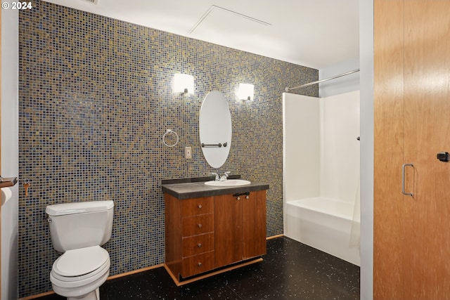 bathroom with toilet, tile walls, and vanity