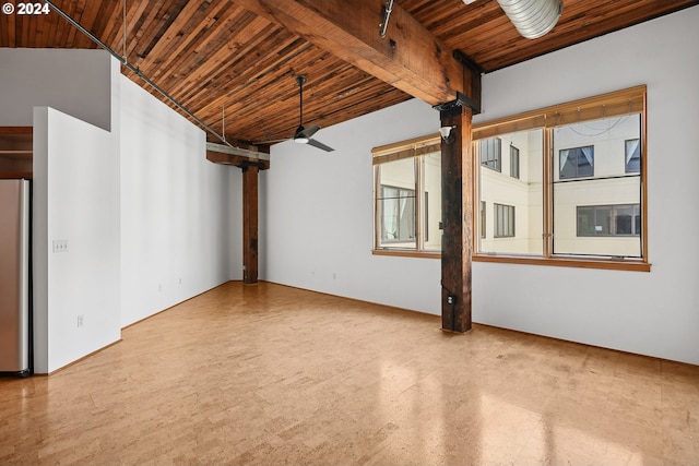 empty room with ceiling fan, beamed ceiling, and wood ceiling