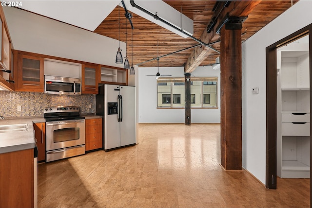 kitchen with stainless steel appliances, ceiling fan, decorative backsplash, pendant lighting, and sink