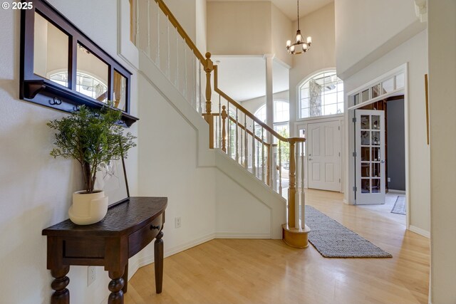 3011 Sabo Ln, West Linn, OR 97068 - foyer entrance featuring a towering ceiling, stairway, wood finished floors, a chandelier, and baseboards