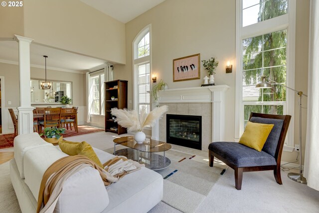 3011 Sabo Ln, West Linn, OR 97068 - carpeted living room with a towering ceiling, decorative columns, a fireplace, and ornamental molding