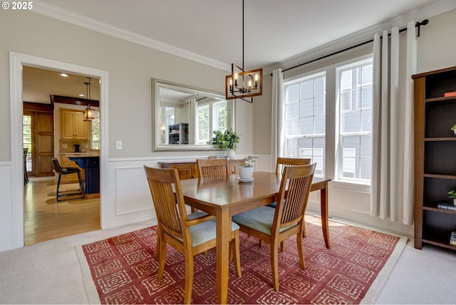 3011 Sabo Ln, West Linn, OR 97068 - dining area with ornamental molding, a decorative wall, a chandelier, plenty of natural light, and light colored carpet