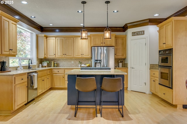 3011 Sabo Ln, West Linn, OR 97068 - kitchen with stainless steel appliances, a sink, light brown cabinets, a center island, and light wood-style flooring