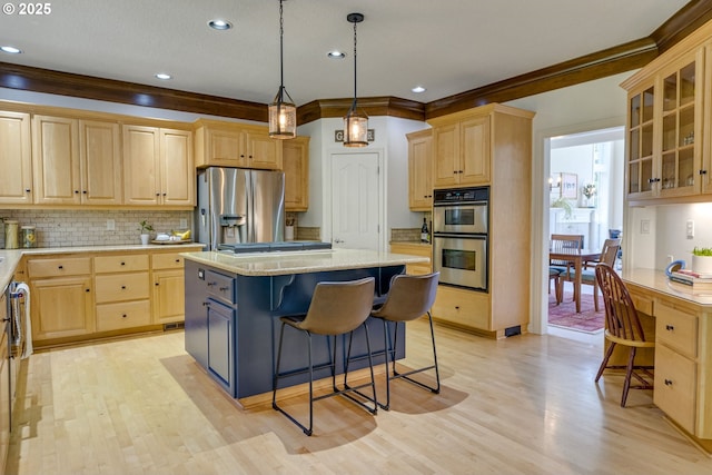 3011 Sabo Ln, West Linn, OR 97068 - kitchen with stainless steel appliances, light brown cabinets, a breakfast bar, tasteful backsplash, and recessed lighting