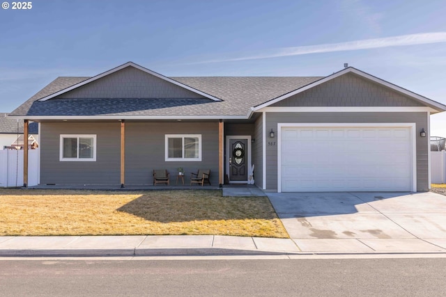 ranch-style home with a garage, a front lawn, concrete driveway, and roof with shingles