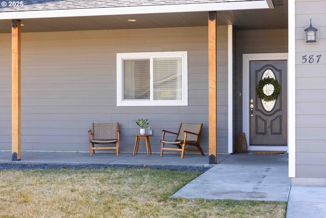 doorway to property with roof with shingles