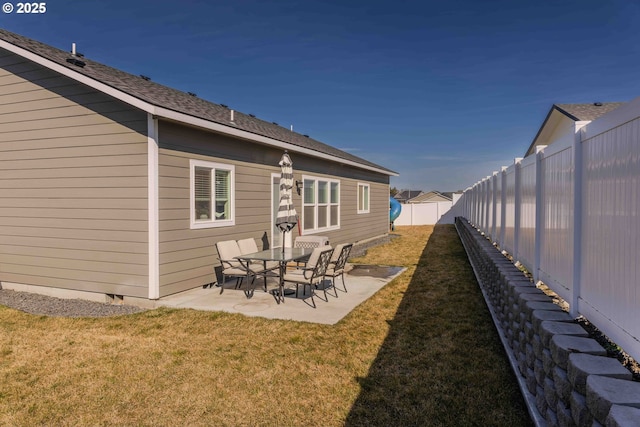 back of house with a yard, a shingled roof, crawl space, a patio area, and a fenced backyard