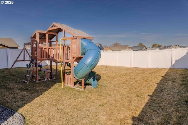 view of playground with a fenced backyard and a lawn