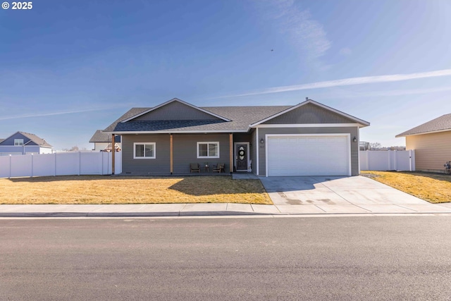 ranch-style house featuring driveway, a garage, roof with shingles, fence, and a front yard