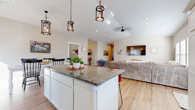 kitchen featuring light wood-type flooring, a center island, and white cabinets