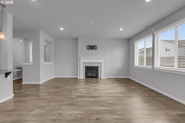 1618 36th Pl, Forest Grove, OR 97116 - unfurnished living room with recessed lighting, wood finished floors, baseboards, and a glass covered fireplace