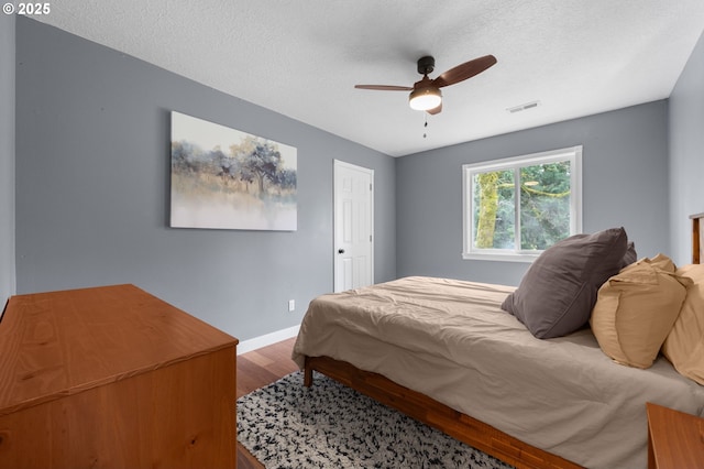 9435 SE 282nd Ave, Boring, OR 97009 - bedroom with wood finished floors, a ceiling fan, and a textured ceiling