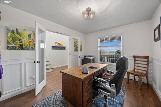 9435 SE 282nd Ave, Boring, OR 97009 - office space featuring wood finished floors, a textured ceiling, a wainscoted wall, french doors, and a decorative wall
