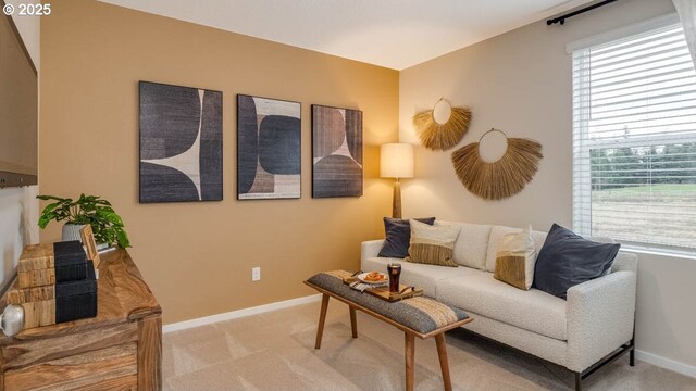 empty room featuring light colored carpet and baseboards