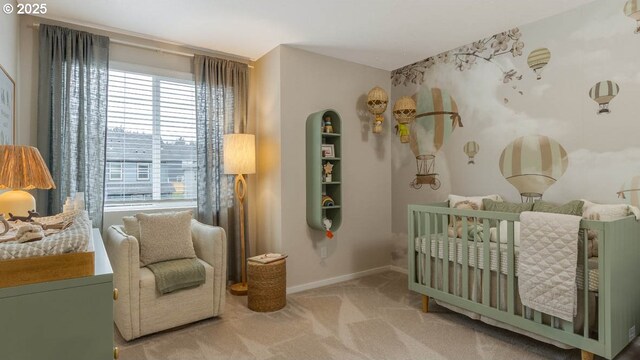 bedroom featuring light carpet, a crib, and baseboards