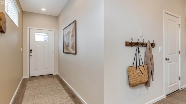 doorway with recessed lighting, wood finished floors, and baseboards