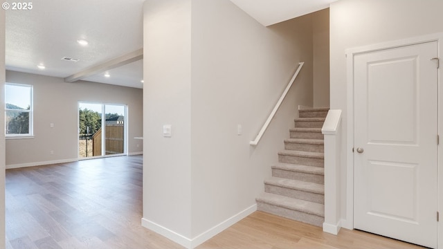 stairs featuring recessed lighting, baseboards, wood finished floors, and beamed ceiling