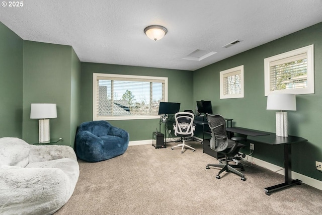 home office featuring carpet, a textured ceiling, visible vents, and baseboards