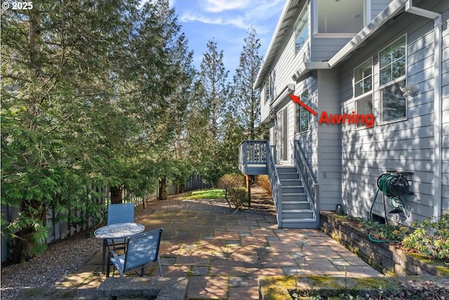 view of patio / terrace with a fenced backyard, a deck, and stairs