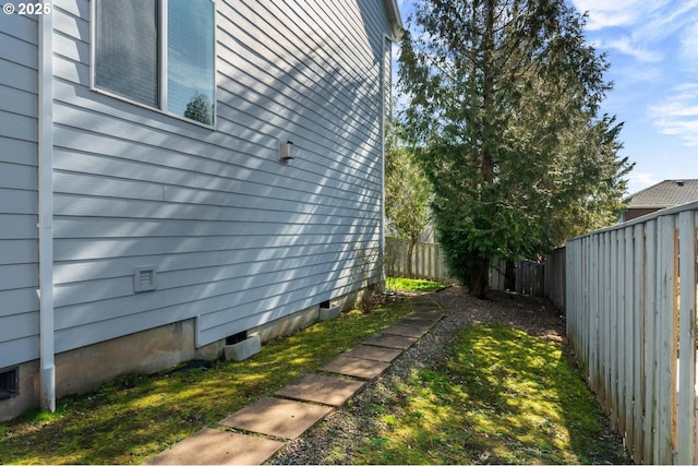 view of property exterior with crawl space and a fenced backyard