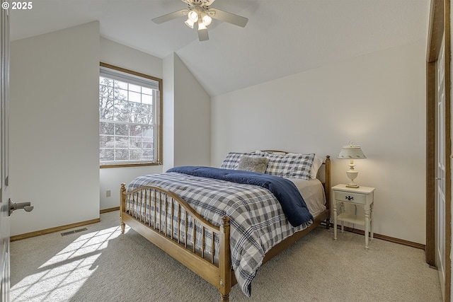 bedroom featuring lofted ceiling, baseboards, visible vents, and ceiling fan