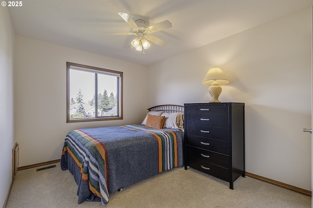 bedroom with visible vents, baseboards, and light colored carpet