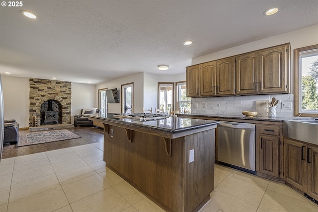 kitchen featuring a kitchen bar, plenty of natural light, appliances with stainless steel finishes, and a kitchen island