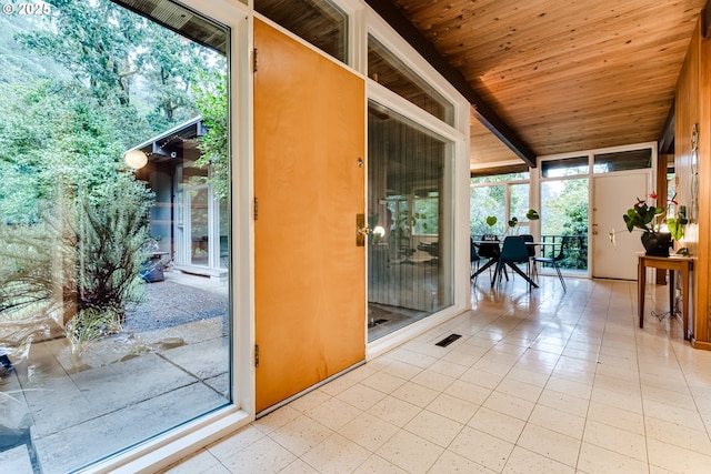 unfurnished sunroom with a healthy amount of sunlight and wooden ceiling